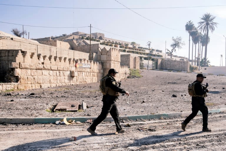 Members of the Iraqi Counter Terrorism Service patrol in front of the Nabi Yunus shrine in eastern Mosul on January 18, 2017