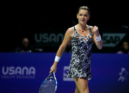 Tennis - Singapore WTA Finals Round Robin Singles - Singapore Indoor Stadium, Singapore - 26/10/2016 - Agnieszka Radwanska of Poland celebrates after defeating Garbine Muguruza of Spain. REUTERS/Edgar Su