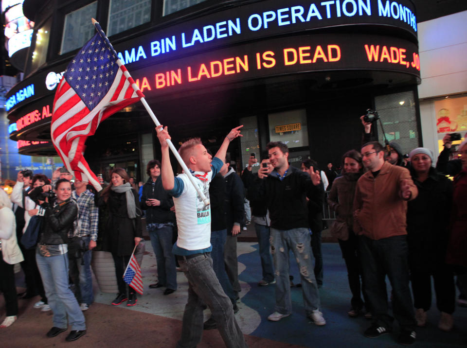 People react to the death of Osama bin Laden in Times Square in New York early May 2, 2011. Al Qaeda leader Osama bin Laden was killed in a firefight with U.S. forces in Pakistan on Sunday, President Barack Obama announced, ending a nearly 10-year worldwide hunt for the mastermind of the September 11 attacks. REUTERS/Eric Thayer