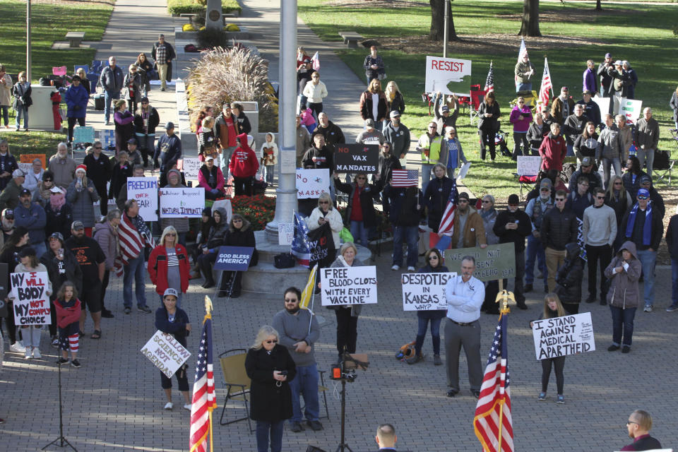 Opponents of COVID-19 vaccine mandates rally outside the Kansas Statehouse, Saturday, Oct. 30, 2021, in Topeka, Kan. The rally drew several hundred people as a legislative committee took testimony about mandates from President Joe Biden that could affect 100 million Americans. (AP Photo/John Hanna)