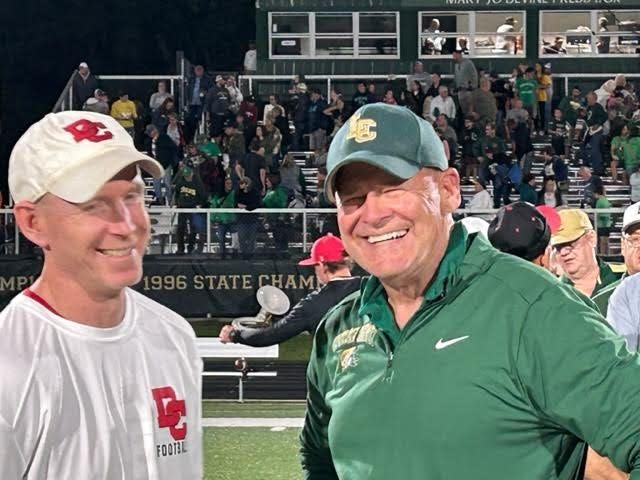 Jackson Lumen Christi head football coach Herb Brogan, who picked up the 400th win of his storied career with a 35-7 victory over Dearborn Divine Child on Sept. 22, 2023 at Jackson Lumen Christi High School, chats with Divine Child assistant coach Dan Deegan.