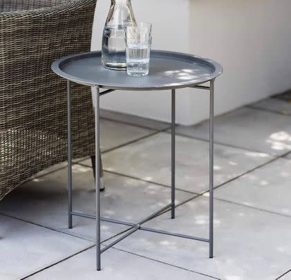 Have this steel side table on hand that can be easily converted into a lap tray