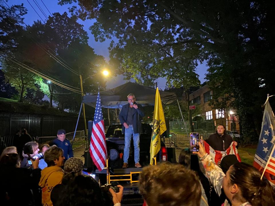 Scott LoBaido, an activist and artist who paints portraits of Donald Trump and American flags, addresses a protest outside of a migrant centre on Staten Island. (Richard Hall / The Independent)