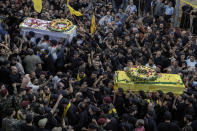 Mourners carry the coffins of victims who were killed Tuesday after their handheld pagers exploded, during their funeral procession in the southern suburb of Beirut, Lebanon, Wednesday, Sept. 18, 2024. (AP Photo/Bilal Hussein)