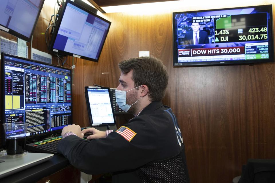 A trader at the New York Stock Exchange works at his terminal, Tuesday, November 24, 2020. The Dow Jones Industrial Average traded above 30,000 points for the first time as investors were encouraged by the latest progress on developing coronavirus vaccines and news that the transition of power in the U.S. to President-elect Joe Biden will finally begin. (Nicole Pereira/NYSE via AP)