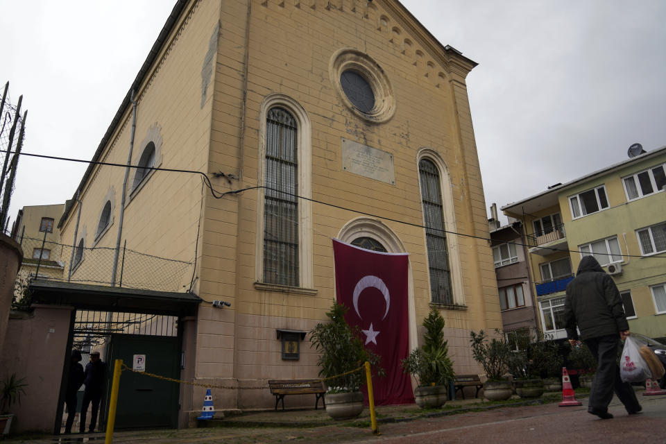 A man walks next to a Roman Catholic church in Istanbul, Turkey Monday, Jan. 29, 2024. The Islamic State group has claimed responsibility for an attack on a Roman Catholic church in Istanbul during a Sunday Mass that killed one person. (AP Photo/Khalil Hamra)