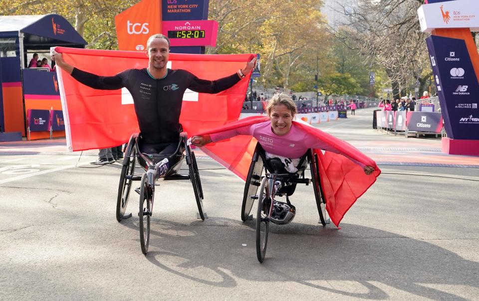 Men's Pro Wheelchair Division winner Marcel Hug of Switzerland and Women's Pro Wheelchair Division winner Catherine Debrunner of Switzerland celebrate at the 2023 New York City Marathon in New York on Nov. 5, 2023