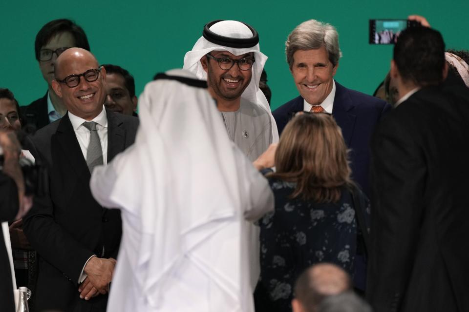 United Nations Climate Chief Simon Stiell, from left, COP28 President Sultan al-Jaber and John Kerry, U.S. Special Presidential Envoy for Climate, pose for photos at the end of the COP28 U.N. Climate Summit, Wednesday, Dec. 13, 2023, in Dubai, United Arab Emirates. (AP Photo/Kamran Jebreili)