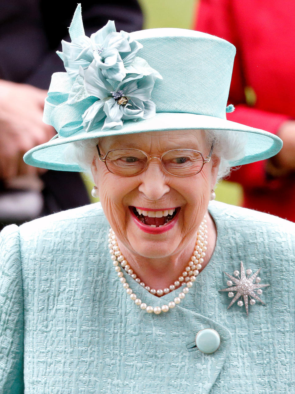 <p>The Queen was all smiles in an ice blue hat with matching flowers while at Royal Ascot on June 23.</p>