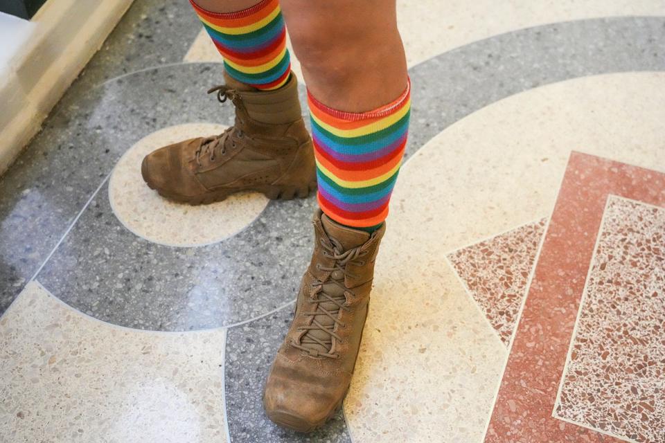 Army veteran Gen Peña wears rainbow socks and combat boots Friday at the Capitol.