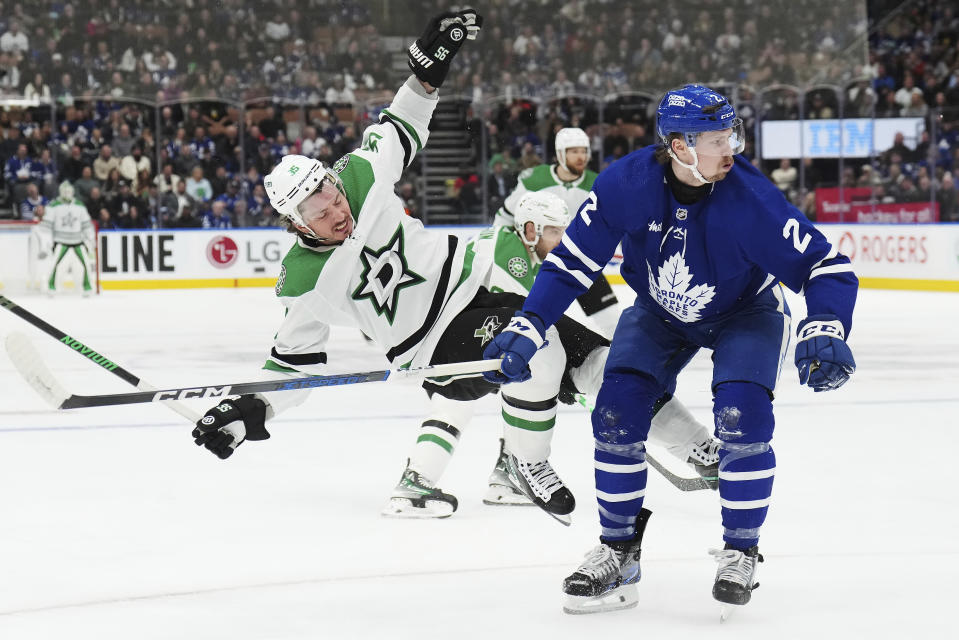 Toronto Maple Leafs defenseman Simon Benoit (2) checks Dallas Stars forward Matt Duchene (95) during the first period of an NHL hockey game Wednesday, Feb. 7, 2024, in Toronto. (Nathan Denette/The Canadian Press via AP)z