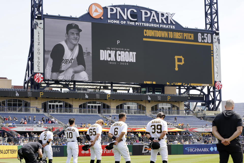 Pittsburgh Pirates players and fans observe a moment of silence in memory of former Pittsburgh Pirates shortstop Dick Groat, who passed away at the age of 92 early Thursday morning, before a baseball game between the Pirates and the Los Angeles Dodgers in Pittsburgh, Thursday, April 27, 2023. (AP Photo/Gene J. Puskar)