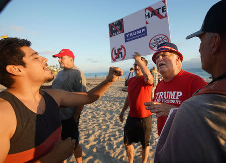 Demonstrators and counter-protesters face off during the America First rally in Laguna Beach, California, U.S., August 20, 2017. REUTERS/Sandy Huffaker