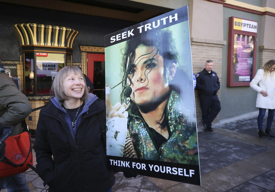 Brenda Jenkyns who drove from Calgary, Canada stands with a sign outside of the premiere of the Leaving Neverland Michael Jackson documentary (Danny Moloshok/Invision/AP)