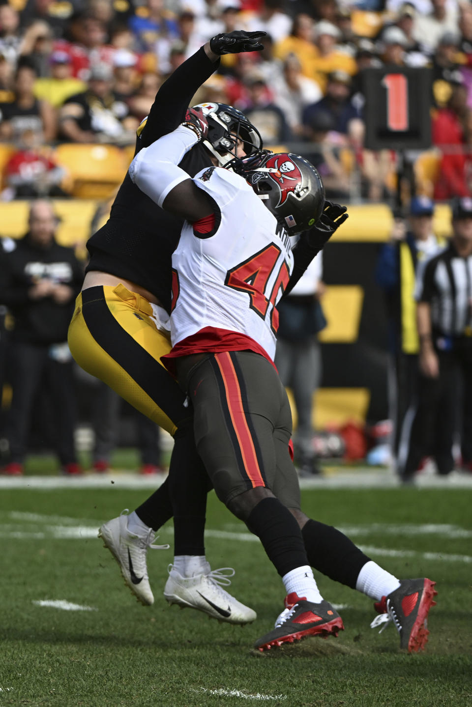 Pittsburgh Steelers quarterback Kenny Pickett, left, is hit by Tampa Bay Buccaneers linebacker Devin White (45) after releasing a pass during the second half of an NFL football game in Pittsburgh, Sunday, Oct. 16, 2022. Pickett was injured on the play and left the game. (AP Photo/Barry Reeger)