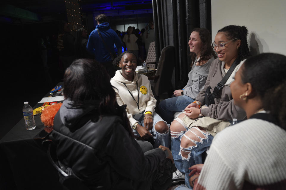 Young clubbers sit together at The Cove, an alcohol free, 18-and-up, pop-up Christian nightclub, on Saturday, Feb. 17, 2024, in Nashville, Tenn. (AP Photo/Jessie Wardarski)