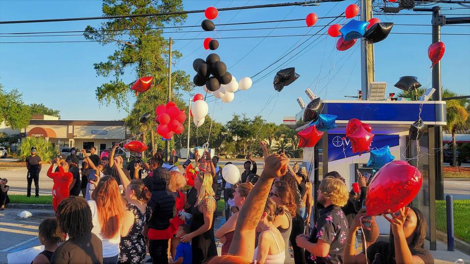 Balloons fly Wednesday night at a VyStar ATM at Bowden and Spring Park roads in Jacksonville in memory of Jamarion Barnes and Tyniya Powell, killed there Monday night, and Jelijah Barnes, Jamarion's brother who was killed in March.