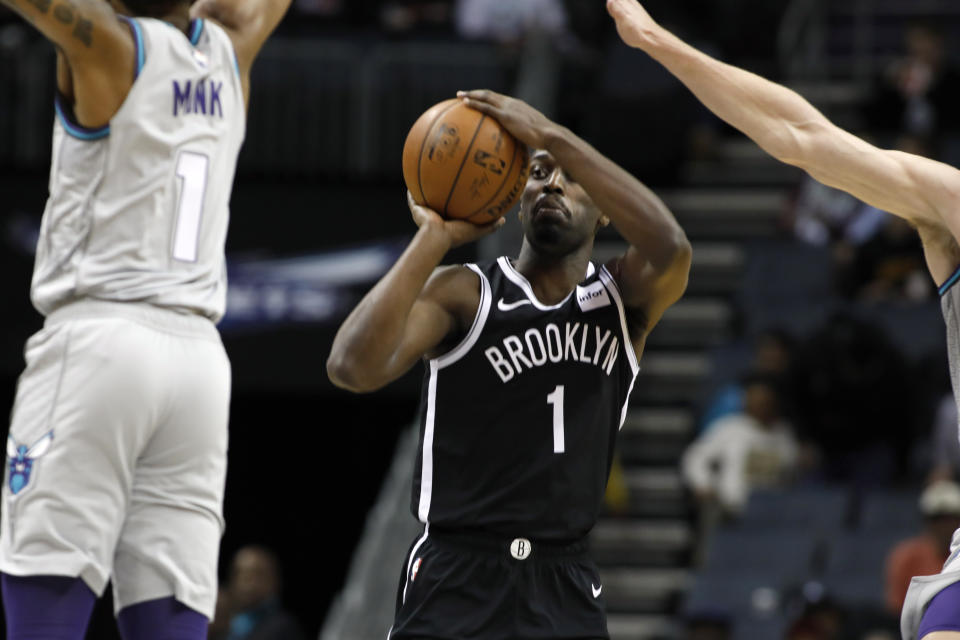 Brooklyn Nets' Theo Pinson (1) prepares to shoot as Charlotte Hornets' Malik Monk (1) defends during the first half of an NBA basketball game in Charlotte, N.C., Friday, Dec. 6, 2019. The Nets won 111-104. (AP Photo/Bob Leverone)