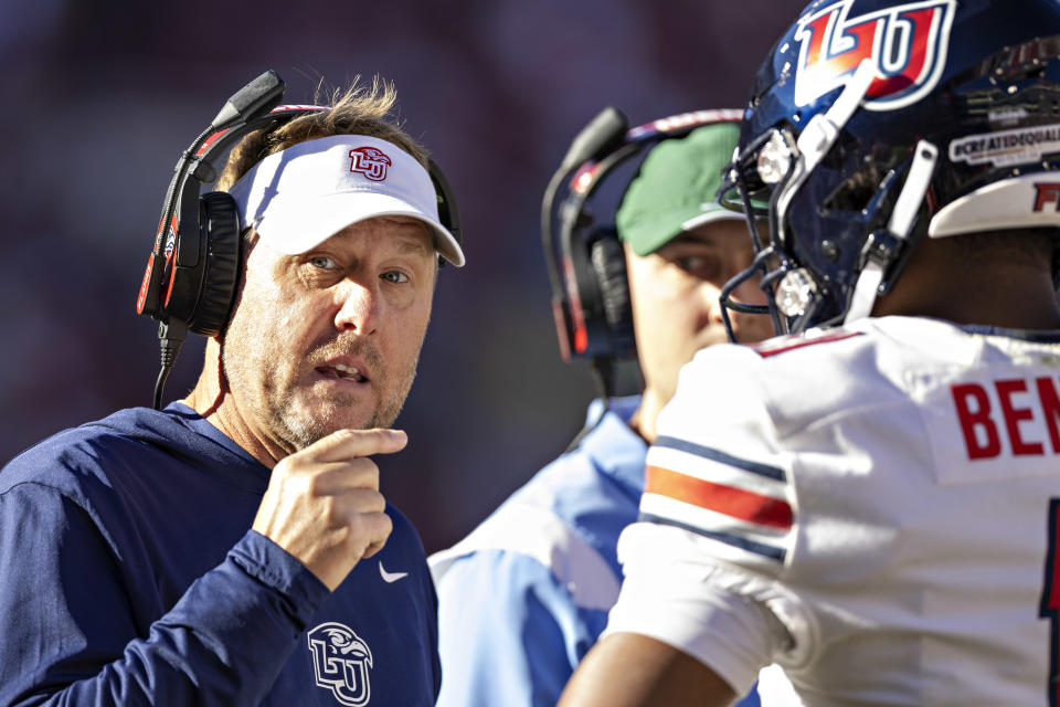 FAYETTEVILLE, ARKANSAS – NOVEMBER 05: Head Coach Hugh Freeze talks with Johnathan Bennett #11 of the Liberty Flames on the sidelines during the first half of a game against the Arkansas Razorbacks at Donald W. Reynolds Razorback Stadium on November 05, 2022 in Fayetteville, Arkansas. (Photo by Wesley Hitt/Getty Images)