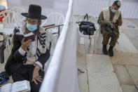 With social distancing barrier, an ultra-Orthodox Jewish man and an Israeli soldier pray ahead of Yom Kippur, the holiest day in the Jewish year which starts at sundown Sunday during a three-week nationwide lockdown to curb the spread of the coronavirus at the Western Wall, the holiest site where Jews can pray in Jerusalem's old city, Sunday, Sept. 27, 2020. The solemn Jewish holiday of Yom Kippur, which annually sees Israeli life grind to a halt, arrived on Sunday in a nation already under a sweeping coronavirus lockdown. (AP Photo/Ariel Schalit)