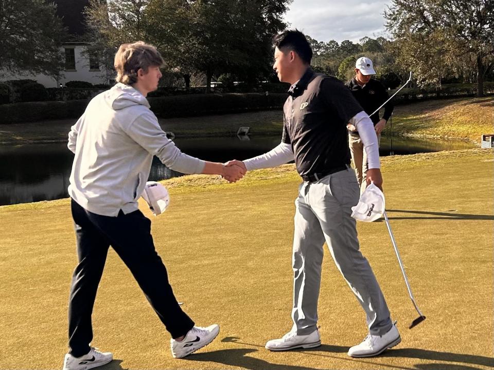 Kent Hsiao of Purdue (right) is congratulated by Brody Stevenson after making the winning putt at No. 18 of Amelia National in the First Coast Amateur.