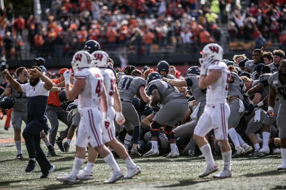 Wisconsin players walk off the field as Illinois celebrates their 24-21 win in an NCAA college football game, Saturday, Oct.19, 2019, in Champaign, Ill. (AP Photo/Holly Hart)