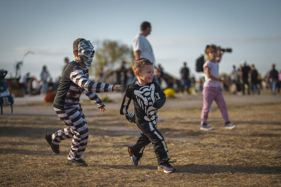 Children play at the West Side Hallo Fest, a Halloween festival in Bucharest, Romania, Saturday, Oct. 28, 2023. Tens of thousands streamed last weekend to Bucharest's Angels' Island peninsula for what was the biggest Halloween festival in the Eastern European nation since the fall of Communism. (AP Photo/Vadim Ghirda)
