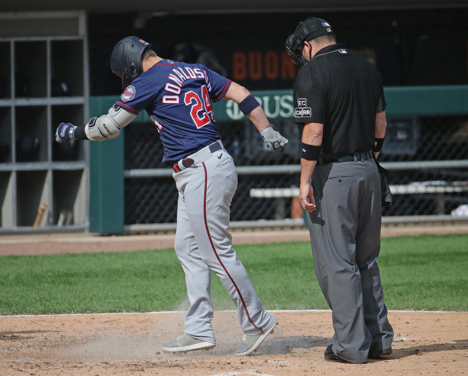 Josh Donaldson of the Minnesota Twins kicks dirt on umpire Dan Bellino. (Photo by Jonathan Daniel/Getty Images)