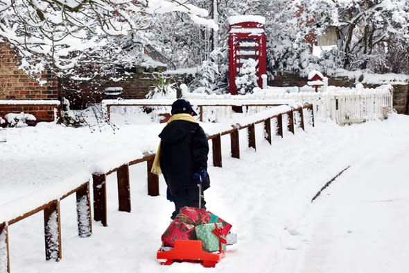 A young boy discovers the traditional way for delivering  presents this Christmas in Husthwaite near Easingwold, as further heavy snowfalls in the area made a white Christmas almost certain.   * With only two days to go to December 25, the PA WeatherCentre said there was a 90% chance of a white Christmas, with Scotland and northern England the most likely. 