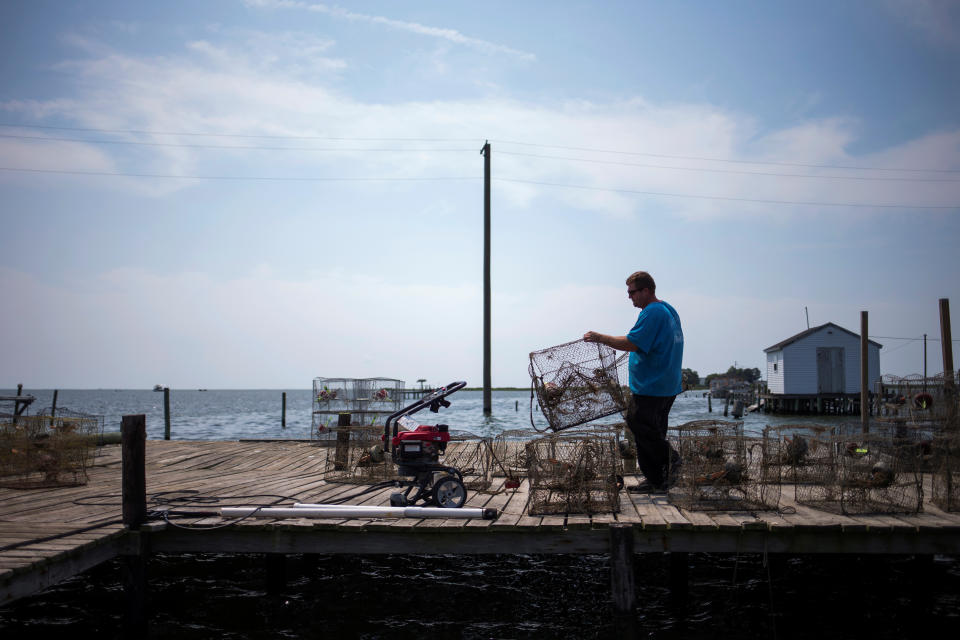 <p>Local islander Jim Shores lays out his crab traps to dry along a dock on Tangier Island, Virginia, Aug. 2, 2017. (Photo: Adrees Latif/Reuters) </p>