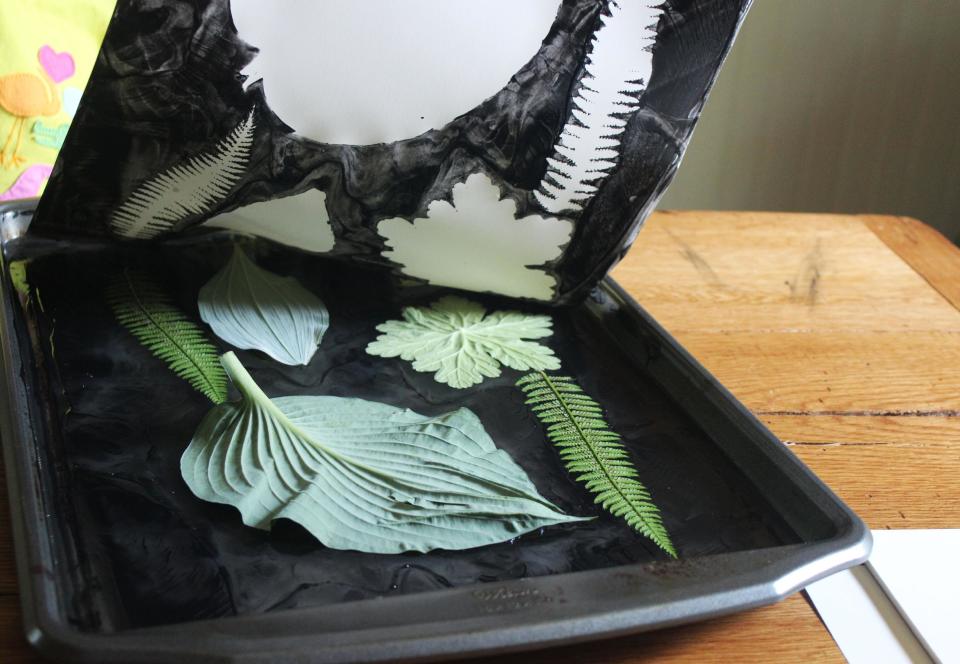 In this undated photo provided by New House Project, paper is carefully peeled away to reveal "negative" leaves in the print by Kristen Sutcliffe as shown here. Gelatin printing is a low-tech craft that uses simple ingredients and tools: a pan of gelatin (such as the Knox brand), ink, paper, maybe an ink brayer and a collection of leaves. (AP Photo/New House Project, Kristen Sutcliffe)