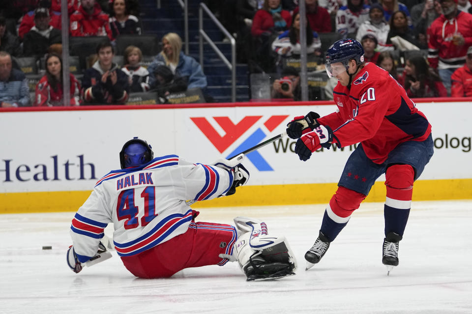 New York Rangers goaltender Jaroslav Halak (41) leaves his crease to make a save against Washington Capitals center Lars Eller (20) during the third period of an NHL hockey game, Saturday, Feb. 25, 2023, in Washington. The Capitals won 6-3. (AP Photo/Julio Cortez)