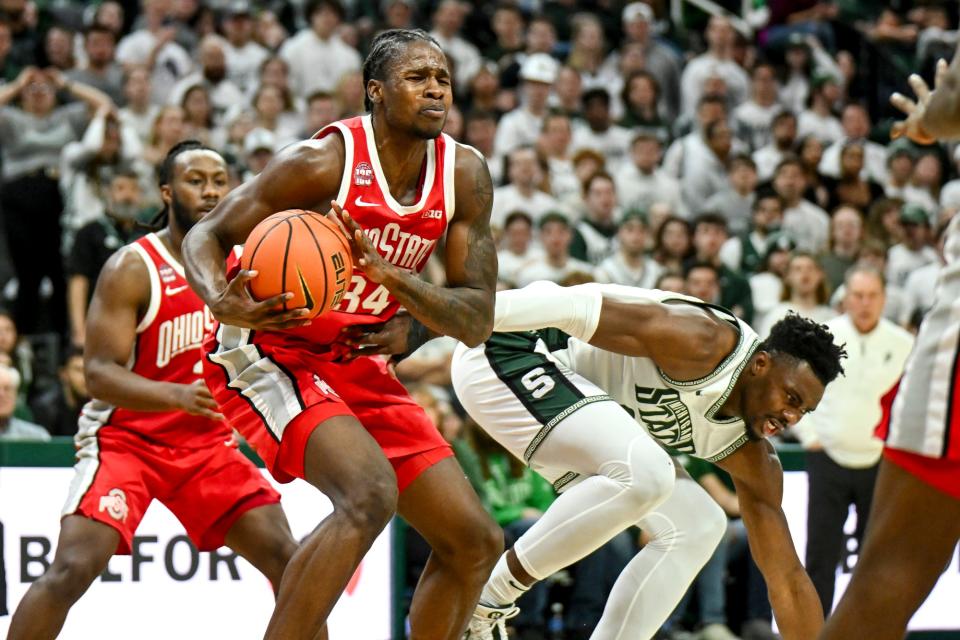 Ohio State's Felix Okpara, left, gets a rebound over Michigan State's Mady Sissoko during the second half on Sunday, Feb. 25, 2024, at the Breslin Center in East Lansing.