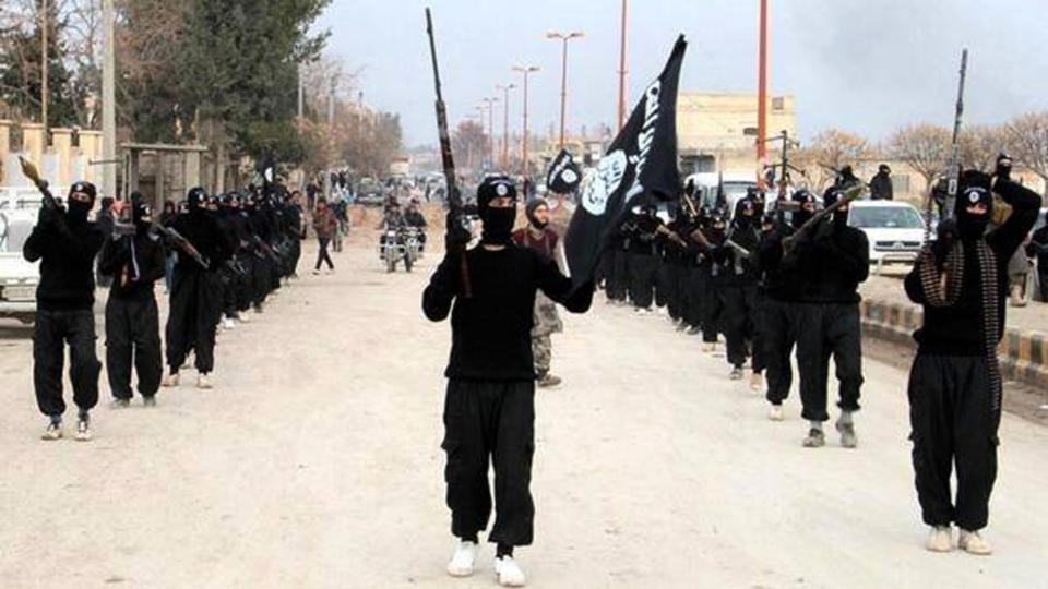 This undated image posted on a militant website on Tuesday, Jan. 14, 2014 shows fighters from the al-Qaida linked Islamic State of Iraq and the Levant (ISIL) marching in Raqqa, Syria. Two weeks of fighting between an al-Qaida-linked group and other rebel forces in Syria has killed more than 1,000 people, an activist group said Thursday, as clashes raged between the rival factions in a northwestern town. The fighting pitting the al-Qaida-linked Islamic State of Iraq and the Levant and other groups are the most serious among rebel forces since the Syrian conflict began in March 2011. (AP Photo/militant website)