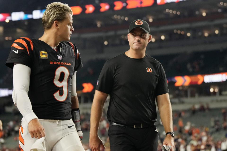 Cincinnati Bengals quarterback Joe Burrow and coach Zac Taylor walk off the field following a loss to the Washington Commanders on Sept. 23, 2024.