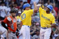 Boston Red Sox's Xander Bogaerts, right, celebrates his three-run home run in front of Baltimore Orioles' Austin Wynns, left, that also drove in Hunter Renfroe (10) during the sixth inning of a baseball game, Saturday, Sept. 18, 2021, in Boston. (AP Photo/Michael Dwyer)