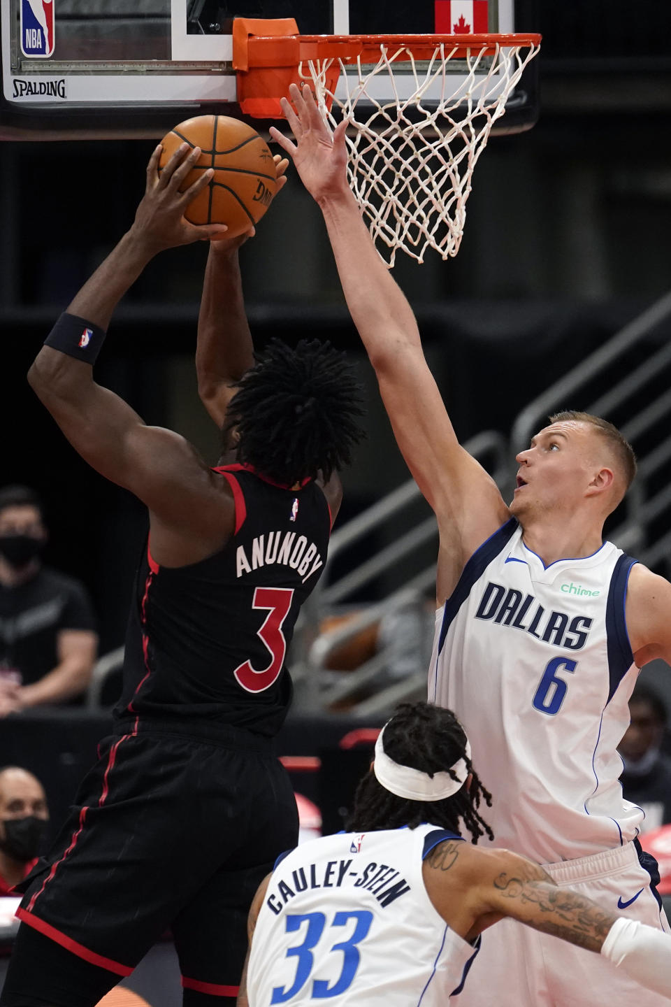 Dallas Mavericks forward Kristaps Porzingis (6) blocks a shot by Toronto Raptors forward OG Anunoby (3) during the second half of an NBA basketball game Monday, Jan. 18, 2021, in Tampa, Fla. (AP Photo/Chris O'Meara)