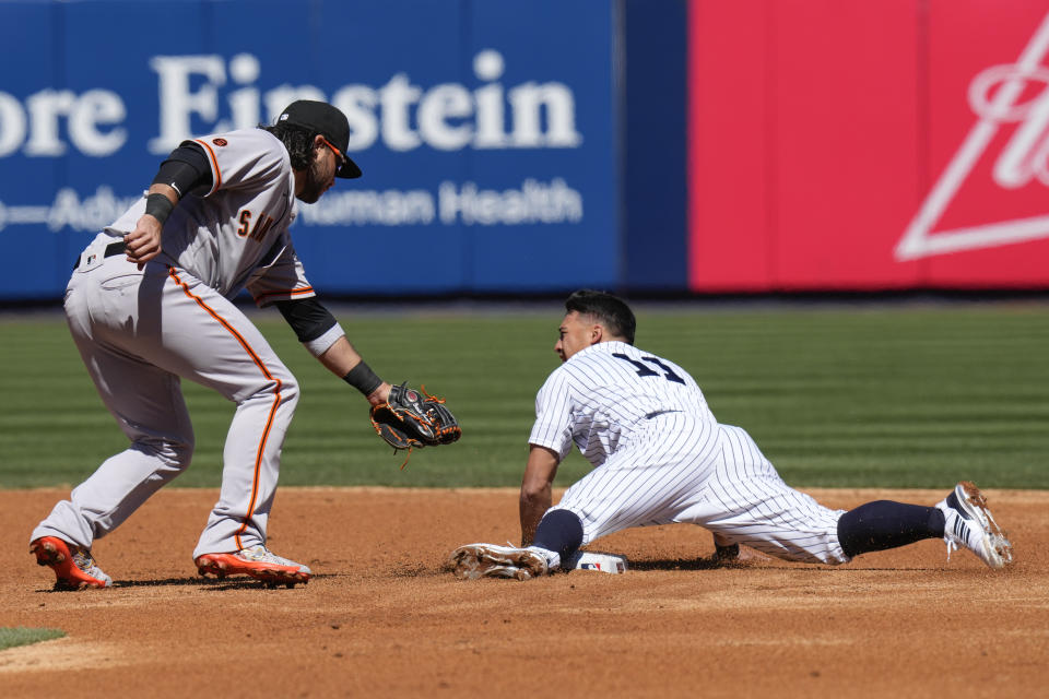 New York Yankees' Anthony Volpe, right, steals second base behind San Francisco Giants shortstop Brandon Crawford during the third inning of an opening day baseball game at Yankee Stadium Thursday, March 30, 2023, in New York. (AP Photo/Seth Wenig)