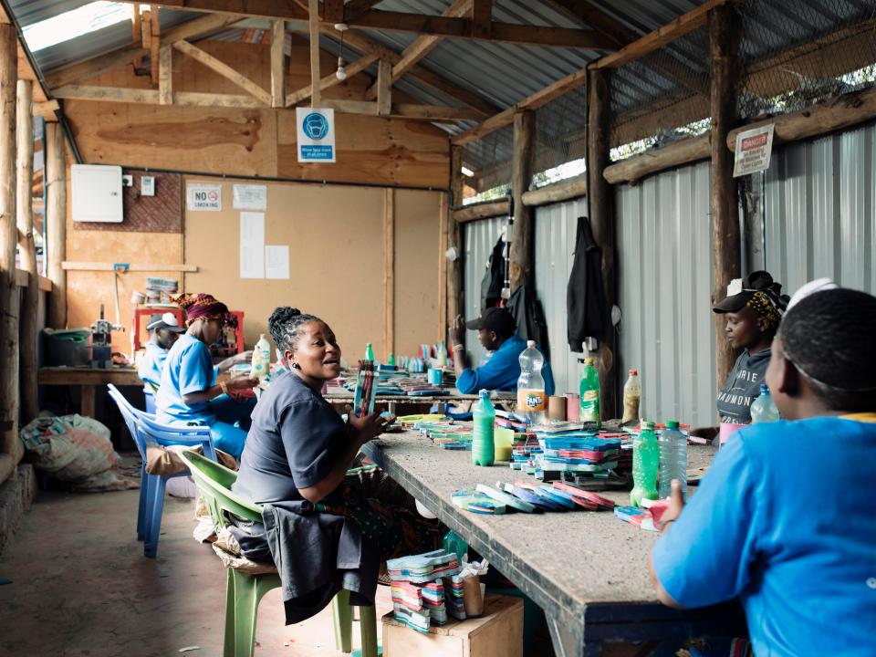 Employees sit and chatter to background music on the radio as they glue the blocks together ready for artists to carvePaddy Dowling