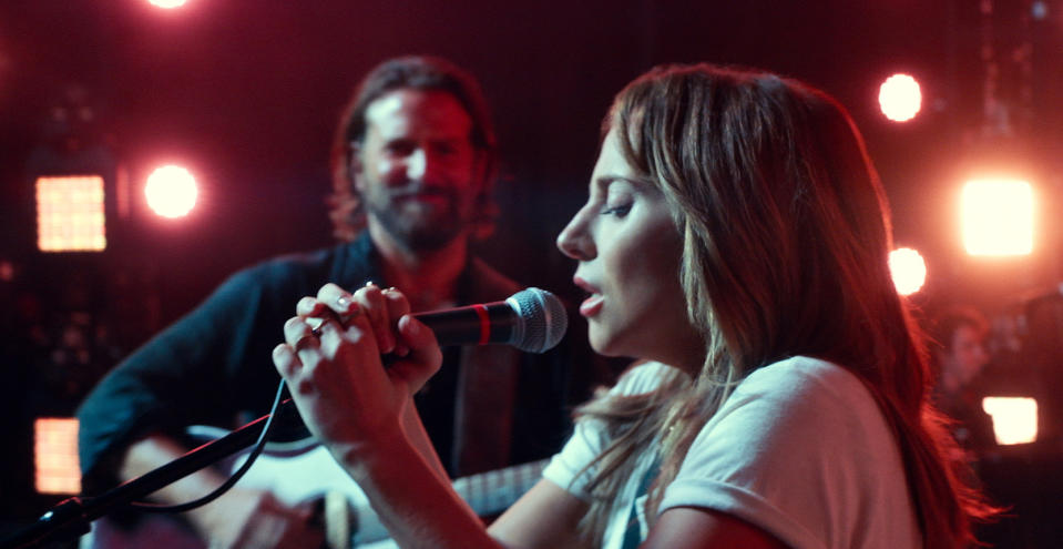 This image released by Warner Bros. shows Bradley Cooper, left, and Lady Gaga in a scene from the latest reboot of the film, "A Star is Born." Surely literal goosebumps are a good sign that you’ve just seen a pretty stunning movie moment, specifically where Lady Gaga’s Ally takes a deep breath and walks out on stage to join Bradley Cooper’s Jackson Maine and sing her song in front of thousands of people. (Neal Preston/Warner Bros. via AP)