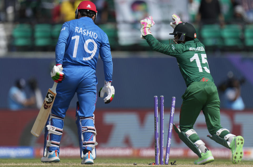 Afghanistan's Rashid Khan is bowled out by Bangladesh's Mehidy Hasan Miraz during the ICC Cricket World Cup match between Afghanistan and Bangladesh in Dharamsala, India, Saturday, Oct.7, 2023. (AP Photo/Ashwini Bhatia)