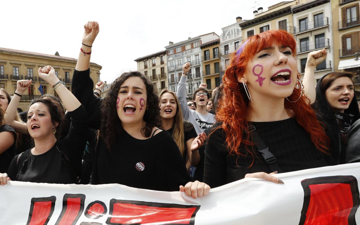 Women during a protest in Pamplona in 2018 after five men, accused of gang raping a woman at Pamplona's bull-running festival, were sentenced to nine years in jail for sexual abuse, avoiding the more serious charge of rape - XABIER LERTXUNDI/AFP