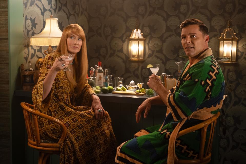 Linda (Laura Dern) sips a Gimlet while Robert (Ricky Martin) drinks a Gin Rickey in "Palm Royale," the new Apple TV+ series set in Palm Beach.