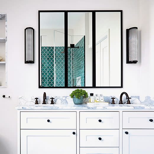 The deep-turquoise fish-scale tiles in the shower, make a decorative statement  - Paul Massey