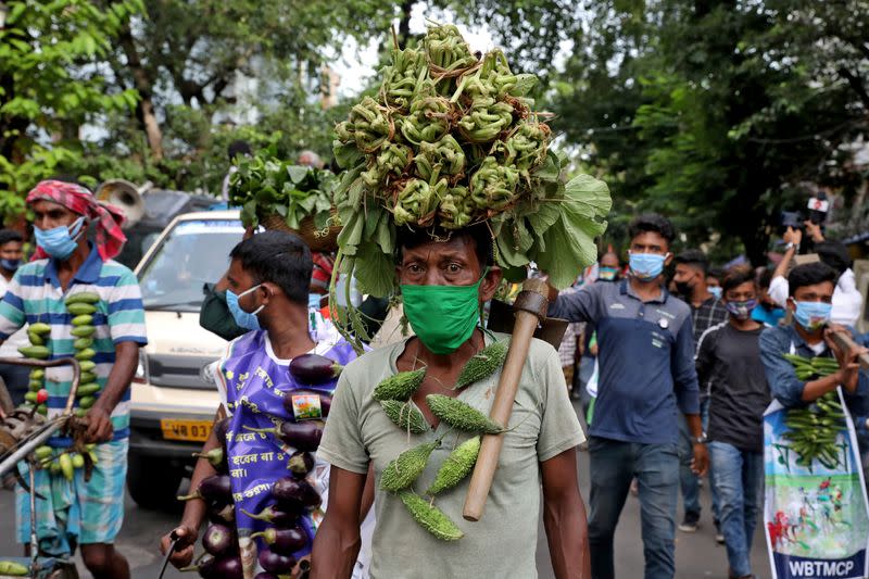 Farmers wearing vegetable garlands attend a protest march against farm bills passed by India's parliament, in Kolkata