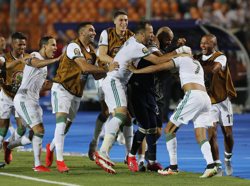 Algerian players celebrate after the African Cup of Nations semifinal soccer match between Algeria and Nigeria in Cairo International stadium in Cairo, Egypt, Sunday, July 14, 2019. (AP Photo/Amr Nabil)