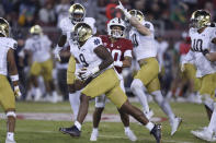 Notre Dame's Justin Ademilola (9) celebrates with teammates after recovering a Stanford fumble during the first half of an NCAA college football game in Stanford, Calif., Saturday, Nov. 27, 2021. (AP Photo/Jed Jacobsohn)