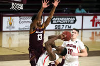 Arizona guard Bennedict Mathurin (0) scores against Arizona State guard Josh Christopher (13) during the second half of an NCAA college basketball game Thursday, Jan. 21, 2021, in Tempe, Ariz. Arizona won 84-82. (AP Photo/Rick Scuteri)