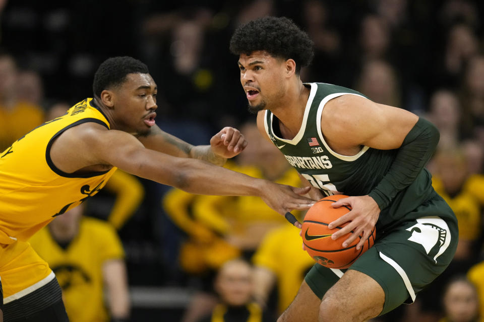 Michigan State forward Malik Hall steals the ball from Iowa guard Tony Perkins, left, during the first half of an NCAA college basketball game, Saturday, Feb. 25, 2023, in Iowa City, Iowa. (AP Photo/Charlie Neibergall)
