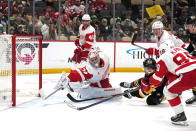 Pittsburgh Penguins' Michael Bunting (8) shoots behind Detroit Red Wings goaltender Alex Lyon (34) for a goal during the second period of an NHL hockey game in Pittsburgh, Sunday, March 17, 2024. (AP Photo/Gene J. Puskar)